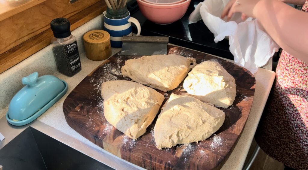 Whole wheat sourdough dough separated into four.