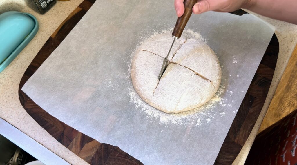 Scoring sourdough with a sourdough scoring tool.