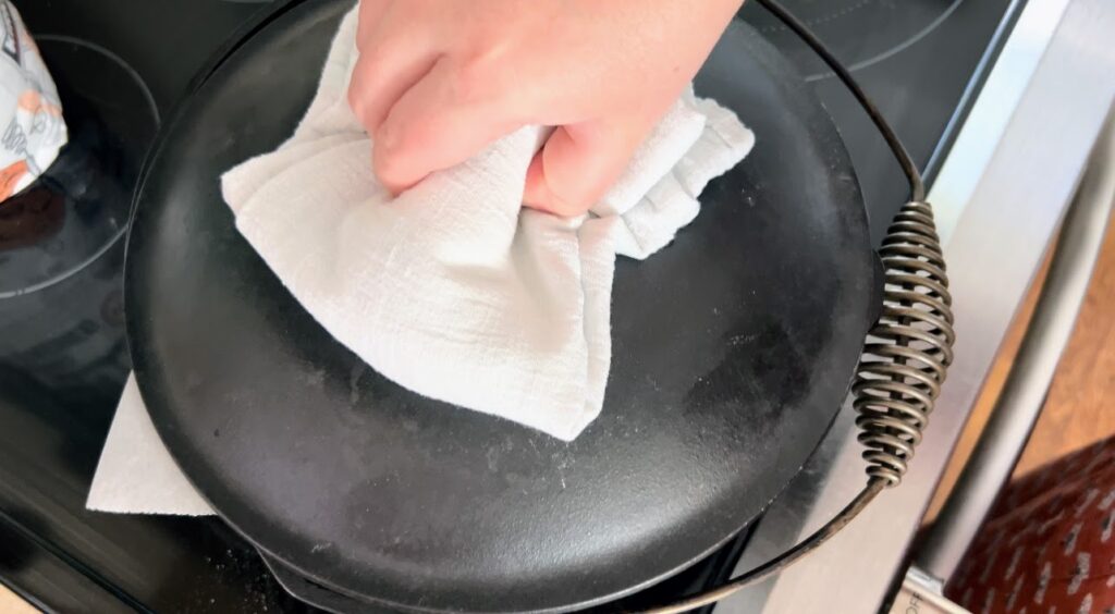 Putting lid on cast iron dutch oven.