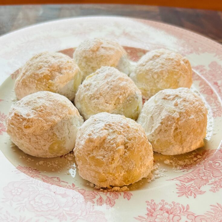 Plate with freshly bakes snowball cookies, also known as Russian tea cakes.