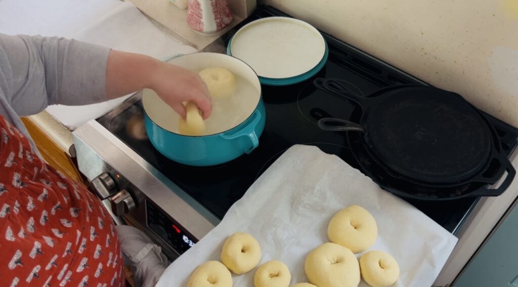 Boiling bagel dough before baking.