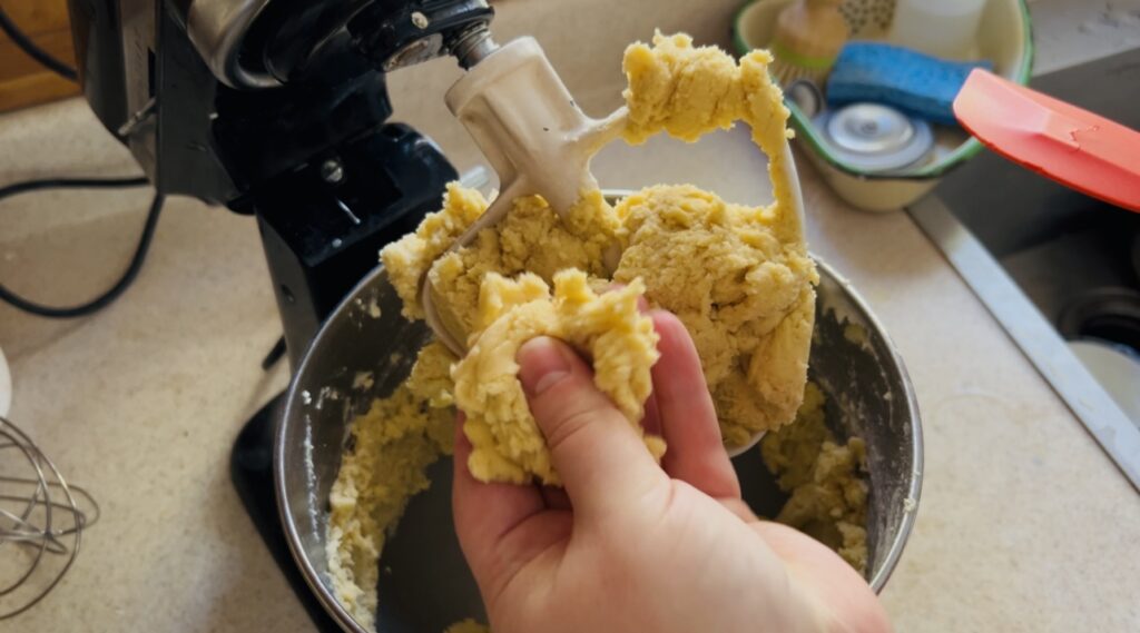 Checking the consistency of thumbprint cookie dough. 