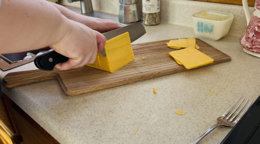 Slicing cheese for make ahead breakfast sandwiches.