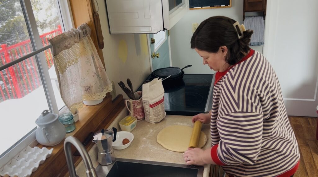 Woman rolling out scone dough for classic scones.