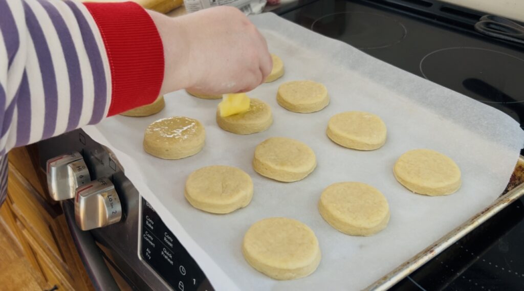 Brushing a simple egg wash to the tops of scone dough before baking.