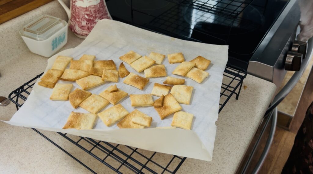 Freshly baked easy sourdough discard crackers cooling on a wire rack.