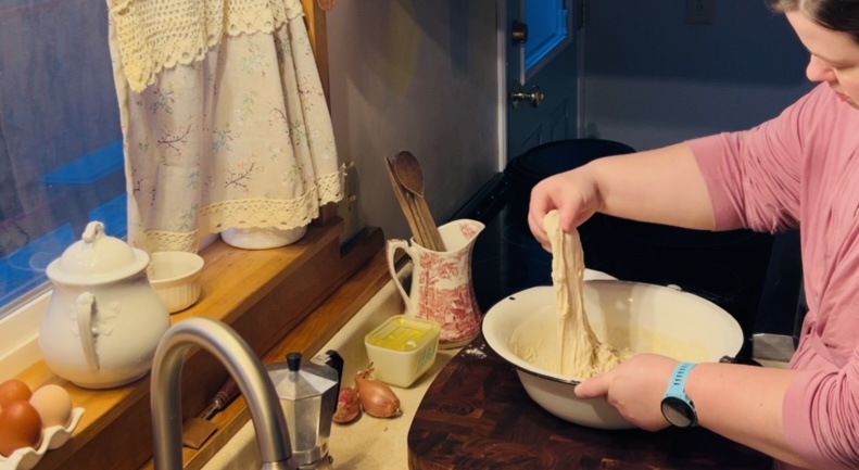 Stretching and folding sourdough dough.