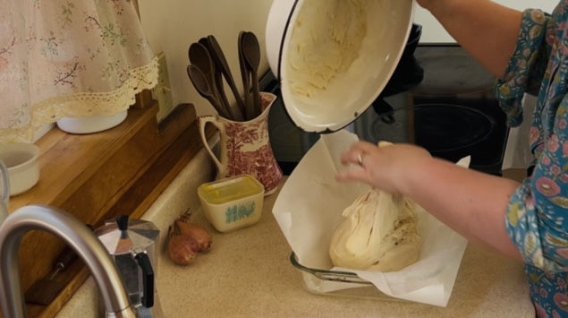 Placing dough into a parchment lined and oiled baking pan.
