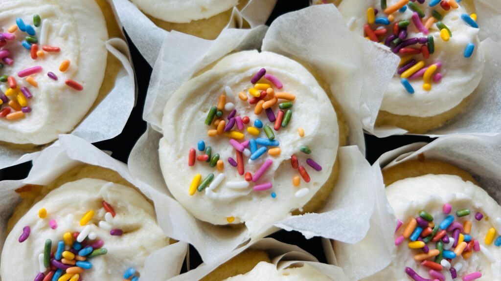 Easy vanilla cupcakes topped with vanilla buttercream frosting and rainbow sprinkles.